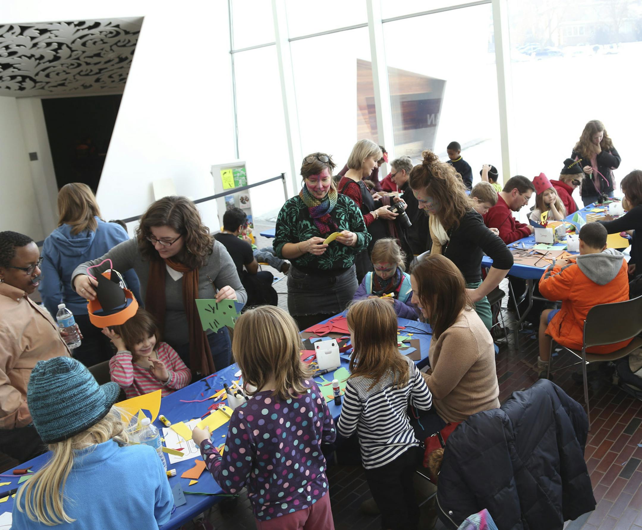 Family and friends helped each other put together masks, costume accessories before taking their portrait during Free First Saturday events at the Walker Art Center in Minneapolis, Min., Saturday January 5, 2012. ] (KYNDELL HARKNESS/STAR TRIBUNE) kyndell.harkness@startribune.com ORG XMIT: MIN1301051607230299