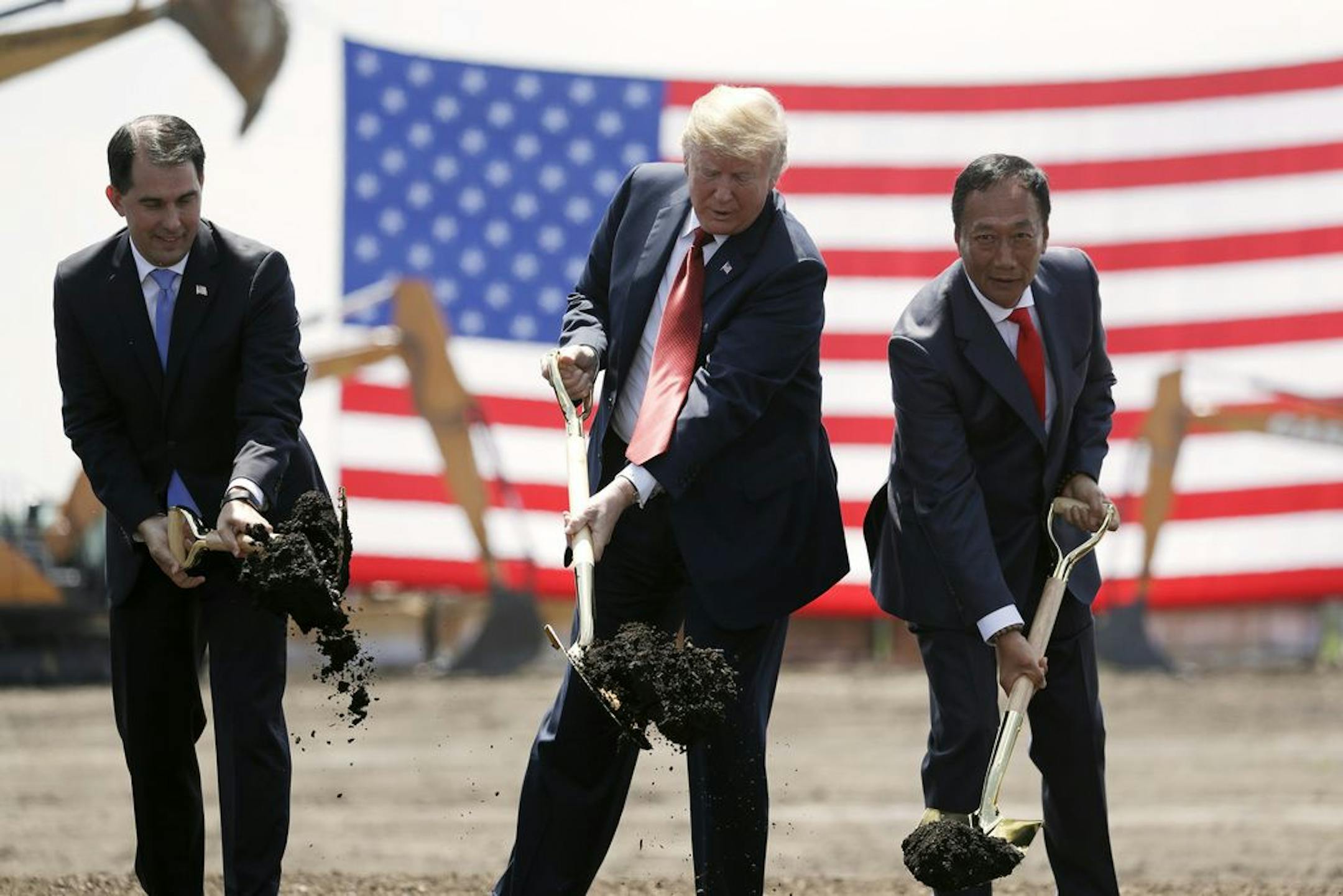 FILE - In this June 28, 2018, file photo, President Donald Trump, center, Wisconsin Gov. Scott Walker, left, and Foxconn Chairman Terry Gou, right, participate in a groundbreaking event for the new Foxconn facility in Mt. Pleasant, Wis.