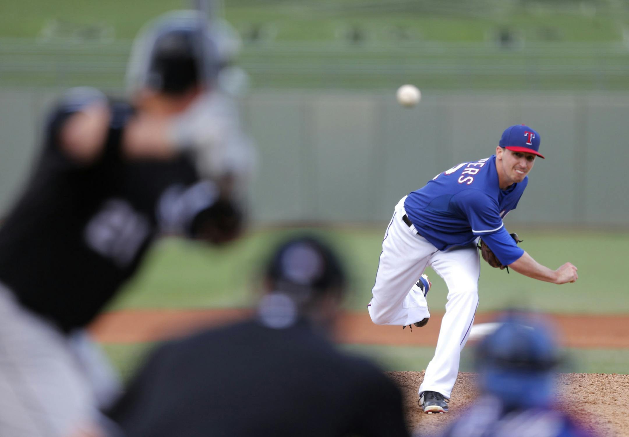 Texas Rangers' Tanner Scheppers pitches in the fourth inning against the Chicago White Sox during a Cactus League game in Surprise, Ariz., on Sunday, March 2, 2014.