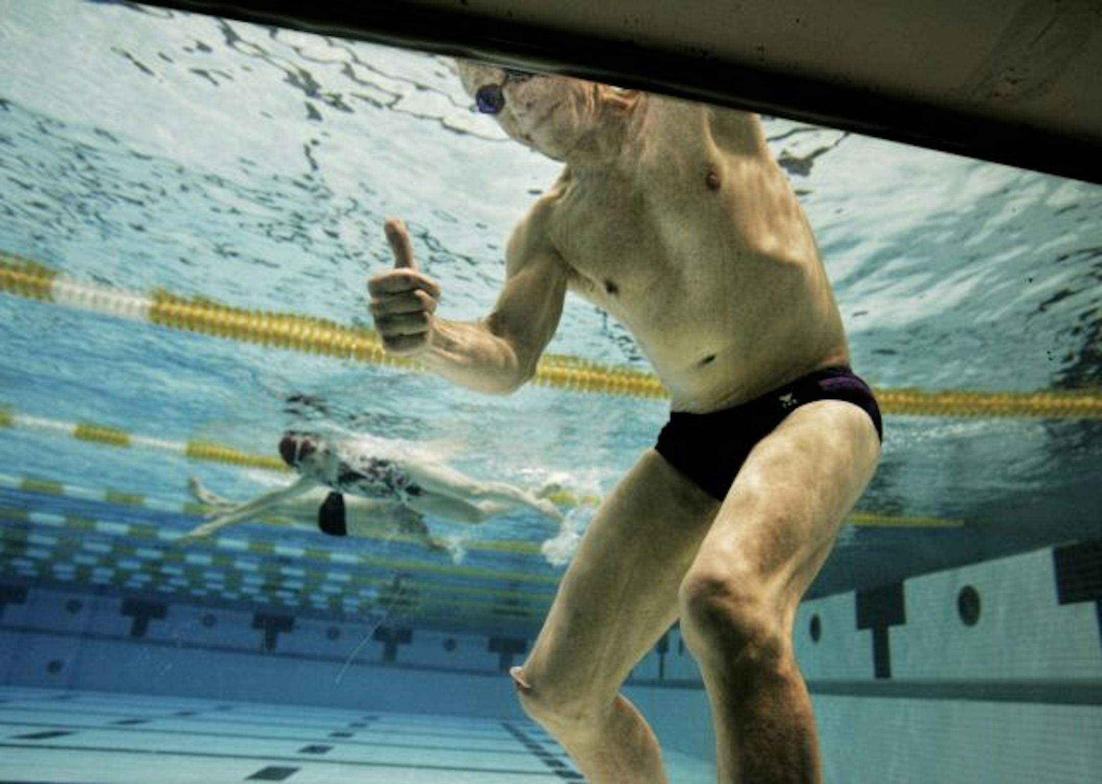 Pete Magee is a 71 year-old masters swimmer from St. Paul who regularly swims at the University of Minnesota Aquatic Center and also lifts weights. He was seen through a viewing window at the Aquatic Center during one of his workouts.