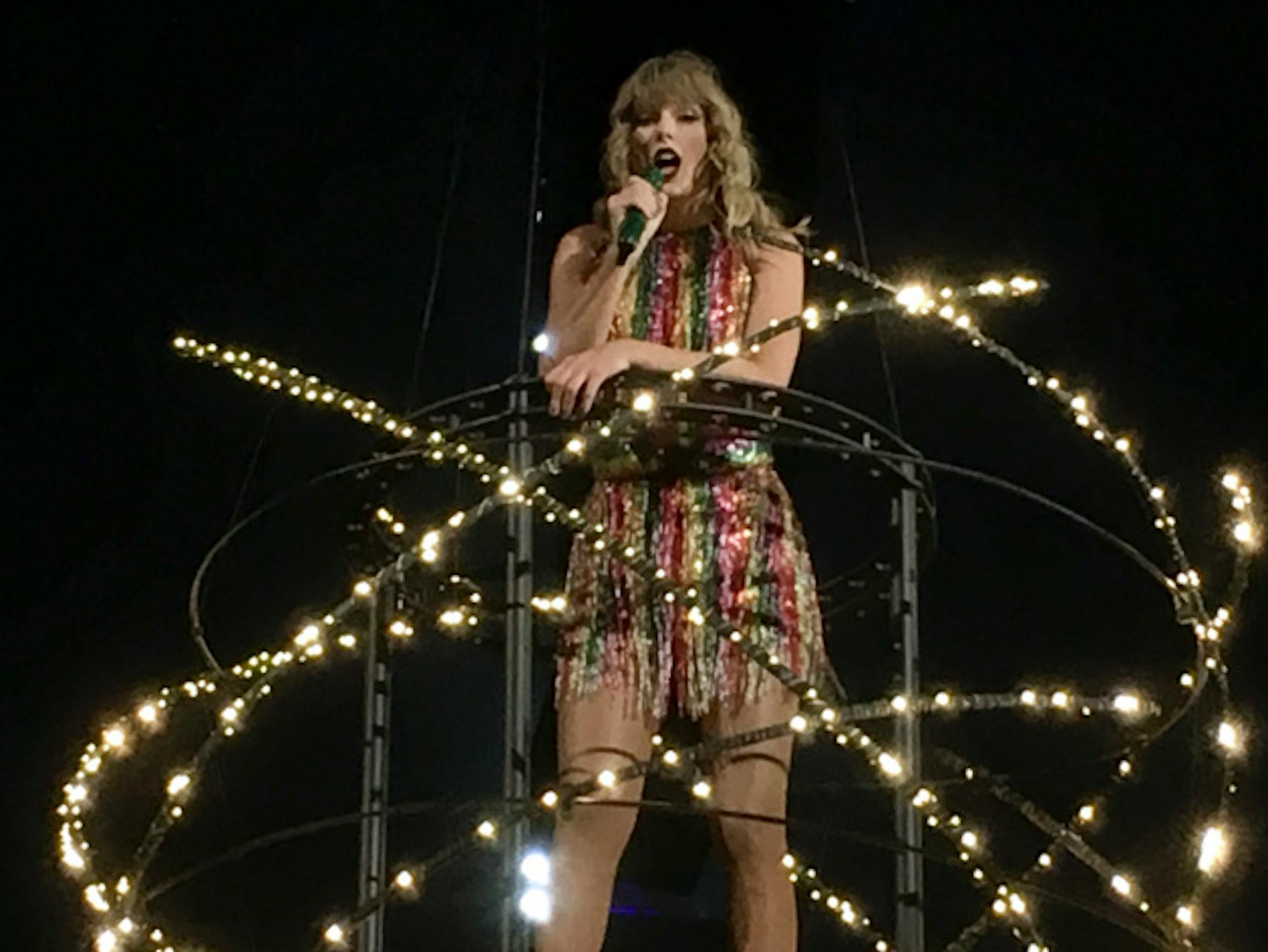 Taylor Swift floating over the crowd singing "Delicate"