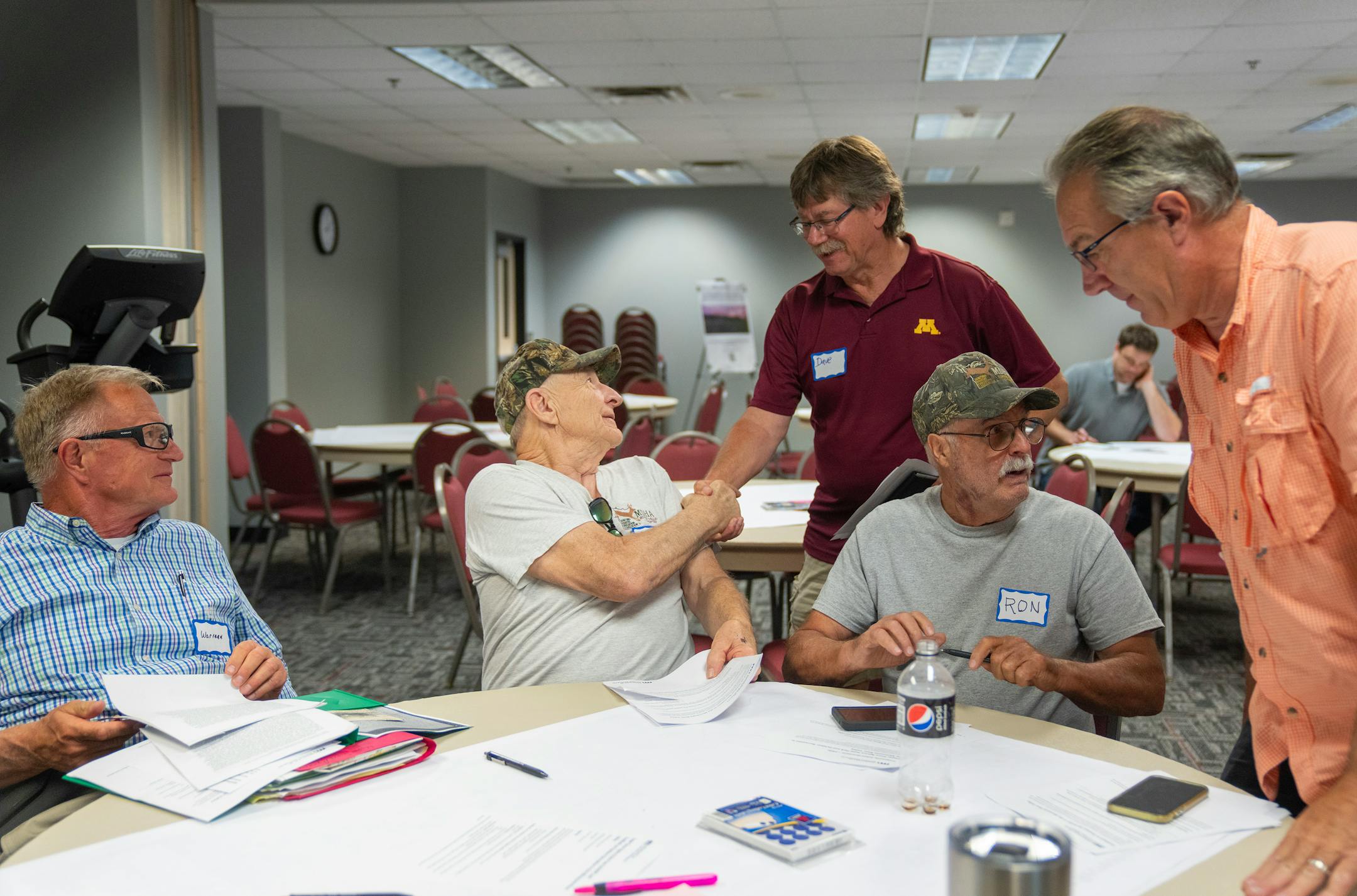 Wayne Eicher shakes hands with Dave Smiglewski, the mayor of Granite Falls, before a DNR public engagement meeting at Kilowatt Community Center in Granite Falls.
