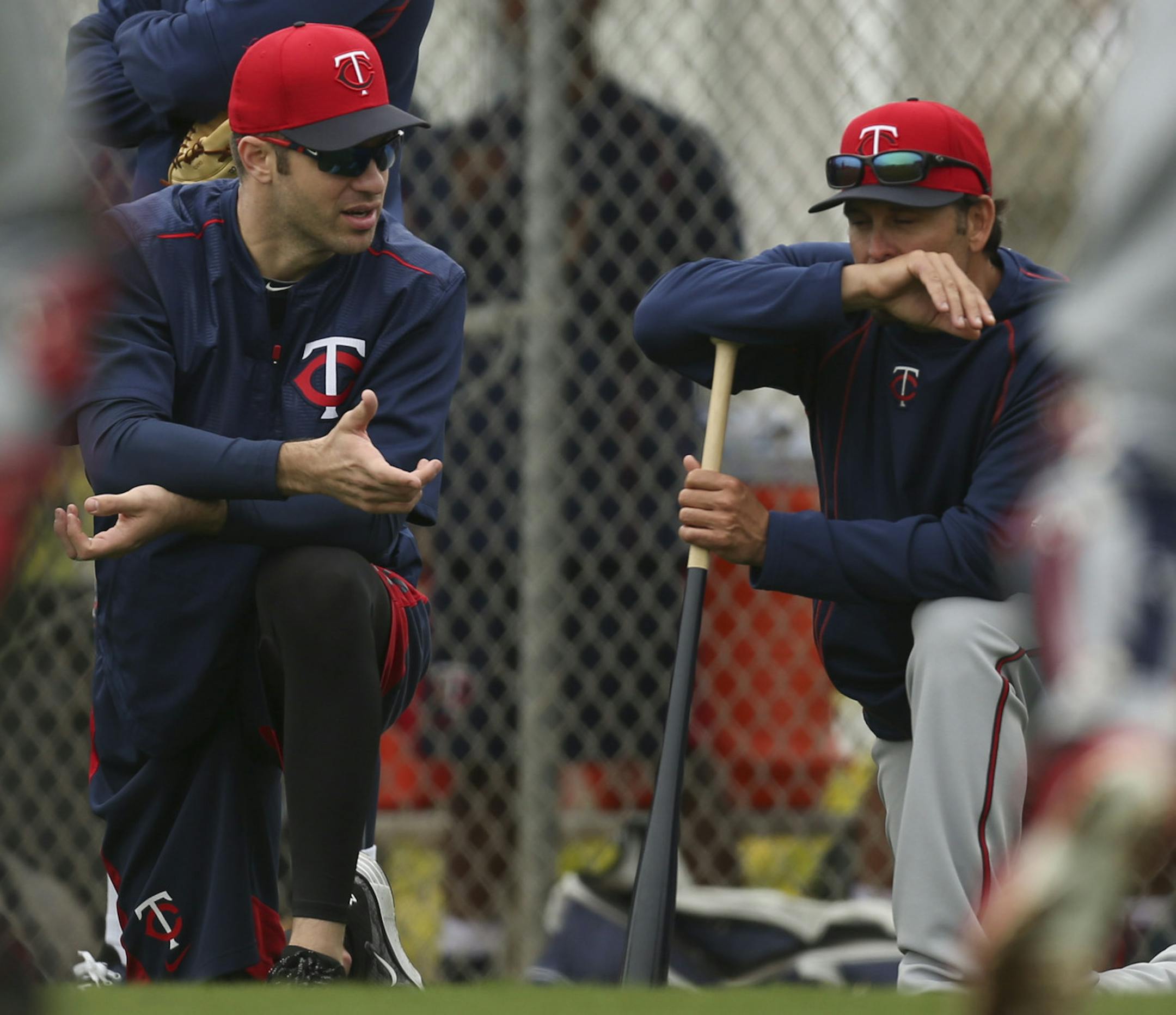Twins first baseman Joe Mauer, left, and former teammate Doug Mientkiewicz between activities at practice Friday morning at Hammond Stadium. Mientkiewicz is the manager of the Chattanooga Lookouts, the Minnesota Twins' Double-A affiliate. ] JEFF WHEELER • jeff.wheeler@startribune.com The entire Twins squad reported to training camp on Friday, February 27, 2015 and worked out after team meetings at Hammond Stadium in Fort Myers, FL.