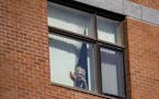 Rose Crist waved down to her daughter, Deana Walkowiak-Olson, from her fourth floor window at St. Ann's Residence in Duluth, MN on Thursday. ] ALEX KO