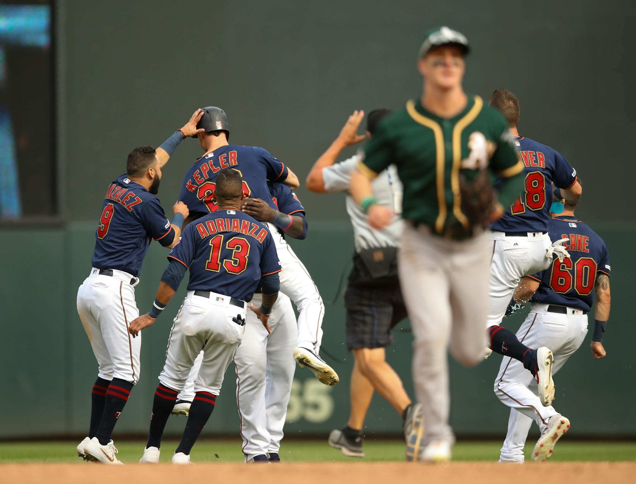 The Twins' Max Kepler was surrounded by celebrating teammates -- and avoided by Oakland players trotting off the field -- after his walkoff single in the ninth inning lifted the Twins over the A's 7-6 at Target Field on Sunday.