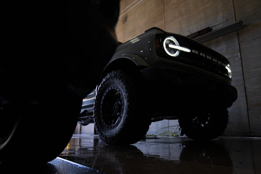 A custom Ford Bronco from Automotive Concepts is rolled into the Minneapolis Convention Center for a rinse during setup Wednesday for the 2024 Twin Cities Auto Show.