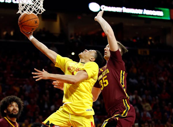 Maryland guard Anthony Cowan Jr., center, shoots against Minnesota center Matz Stockman, right, of Norway, and forward Jordan Murphy (3) in the second