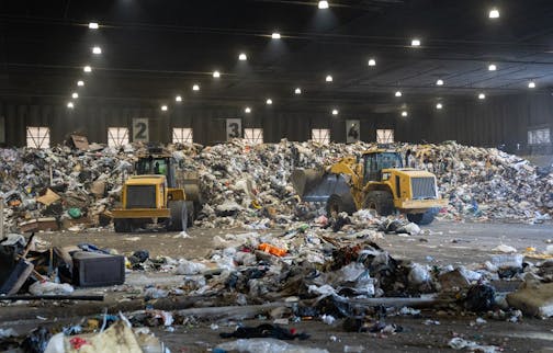 Piles of trash are collected and sorted on the main tipping floor Thursday, Nov. 09, 2023, at Ramsey/Washington Recycling & Energy Center in Newport, Minn.