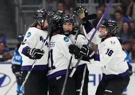 Minnesota's Sophia Kunin (11) gets mobbed by teammates Lee Stecklein (2), Liz Schepers (21) and Sophie Jaques (16) after her empty-net goal during the