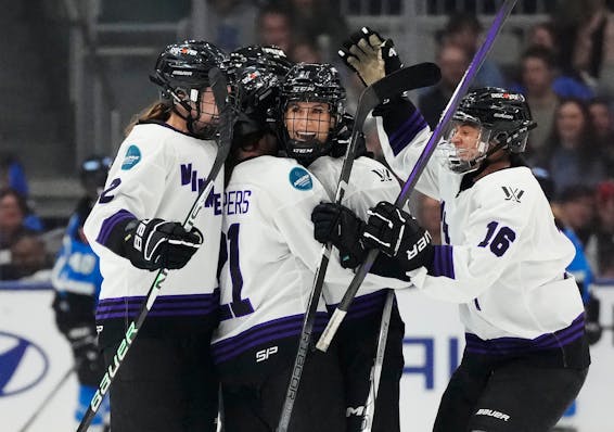 Minnesota's Sophia Kunin (11) gets mobbed by teammates Lee Stecklein (2), Liz Schepers (21) and Sophie Jaques (16) after her empty-net goal during the