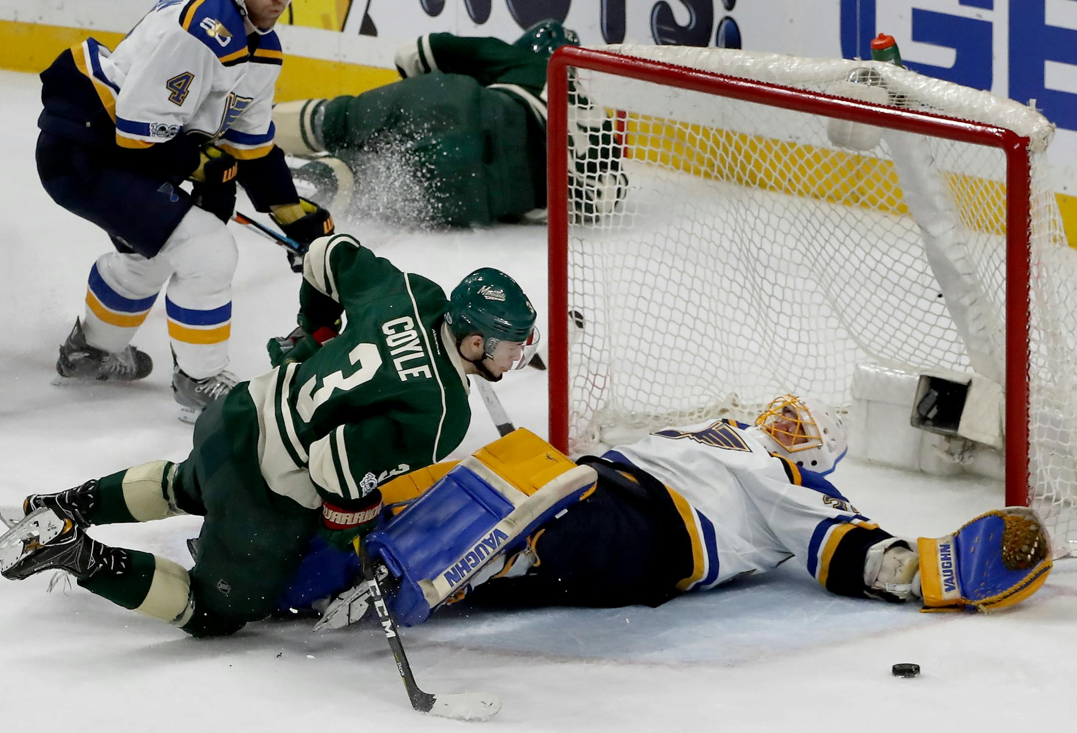 Charlie Coyle (3) could not get the puck past Blues goalie Jake Allen (34) as Eric Staal (12) crashed into the boards in the second period. Staal had to be helped off the ice after the play.