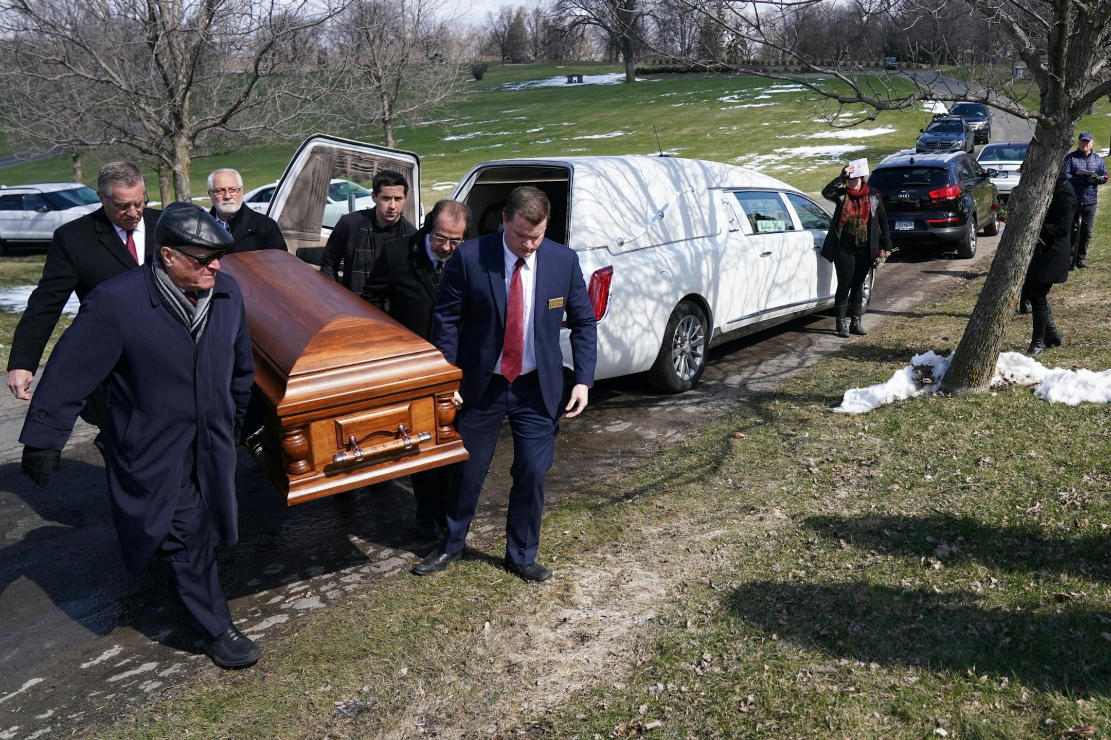 Pallbearers carried the casket of Elie Farhat, who recently died of COVID-19 at the age of 92, to his gravesite Thursday.