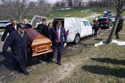 Pallbearers carried the casket of Elie Farhat, who recently died of COVID-19 at the age of 92, to his gravesite Thursday.