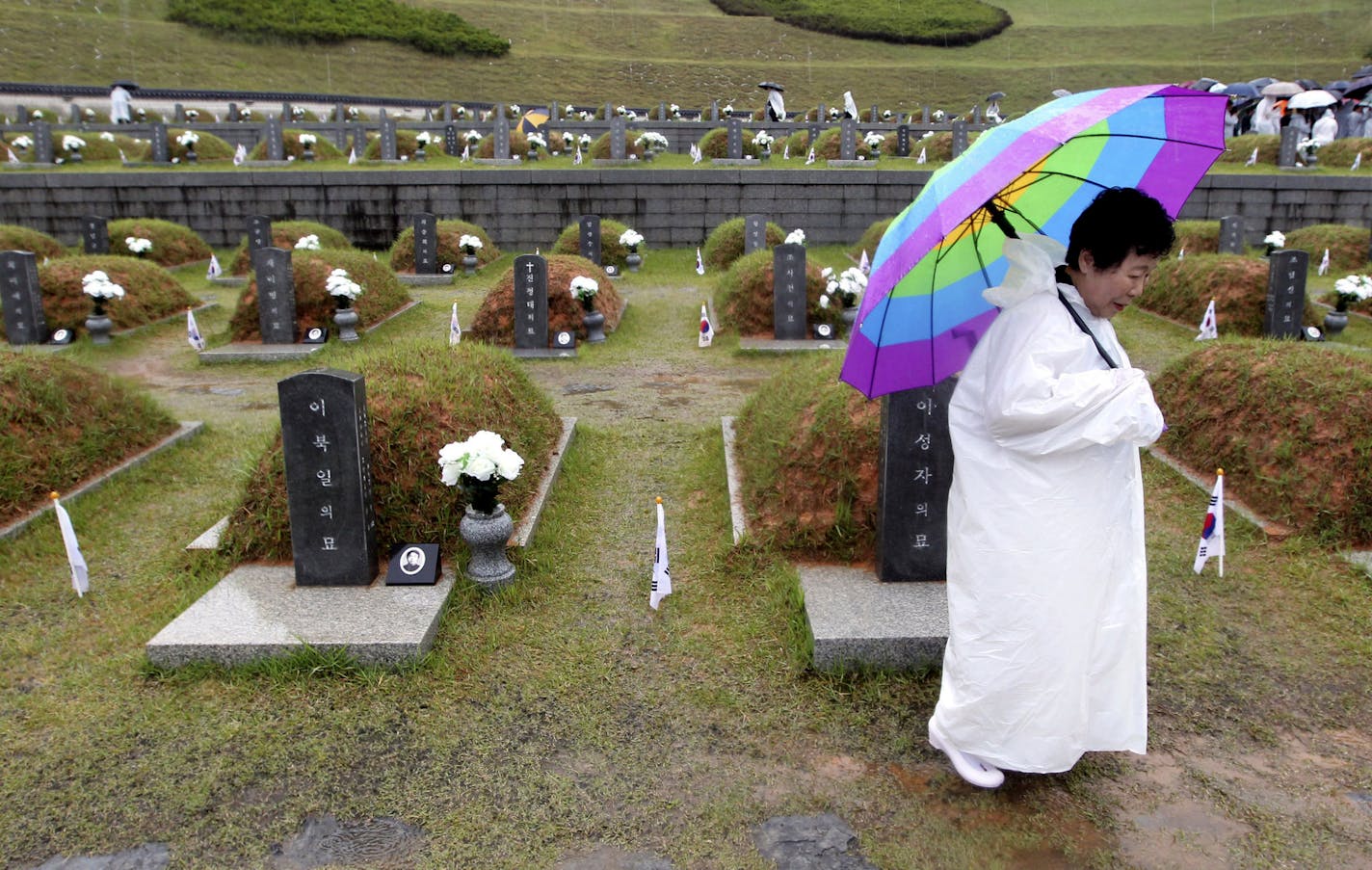 An unidentified relative of victims of 1980 Gwangju civilian uprising arrives to participate in a ceremony marking the 30th anniversary at the May 18 National Cemetery in Gwangju, South Korea, Tuesday, May 18, 2010. According to government figures, more than 200 people were killed in the bloody crackdown on the uprising against the military coup led by former President Chun Doo-hwan. (AP Photo/Yonhap, Hyung Min-woo) ** KOREA OUT ** ORG XMIT: SEL805