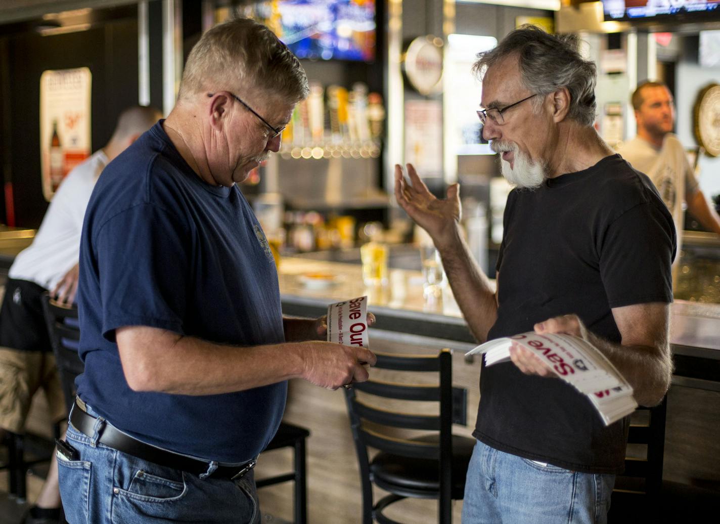 David Cooley gives Brad Johnson, Commander of the American Legion Saint Louis Park Post 282, bumperstickers he is handing out to support the cause. ] ALEX KORMANN &#x2022; alex.kormann@startribune.com David Cooley, 69, of Excelsior is a veteran with an assortment of serious medical conditions including several cancers, a pacemaker and PTSD from the Vietnam war. These days he spends many of his days working to oppose privatization of of veterans medical services, which is already beginning to hap