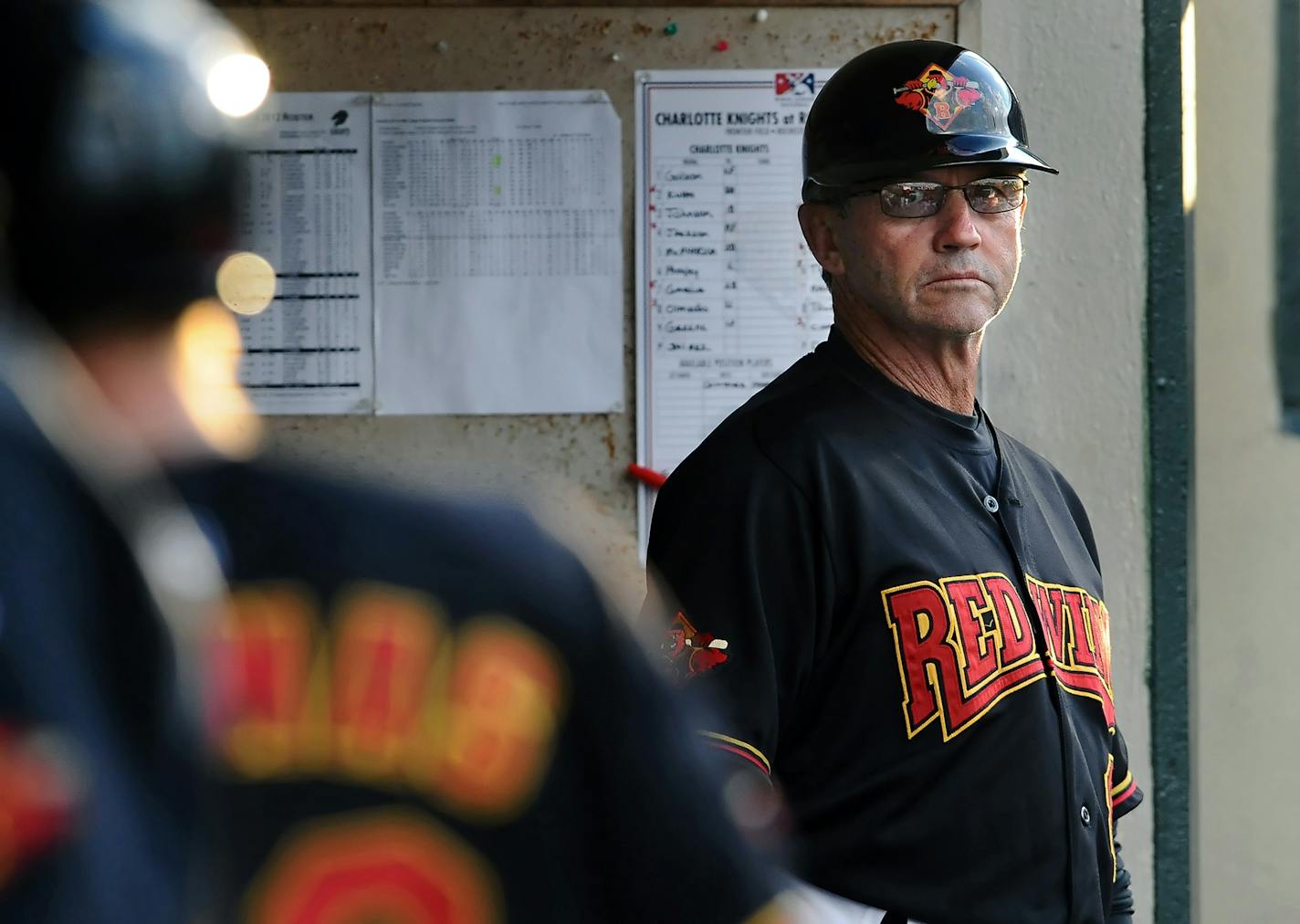 Rochester Red Wings' manager Gene Glynn watches from the dugout during game against the Charlotte Knights at Frontier Field on Monday, June 25, 2012.