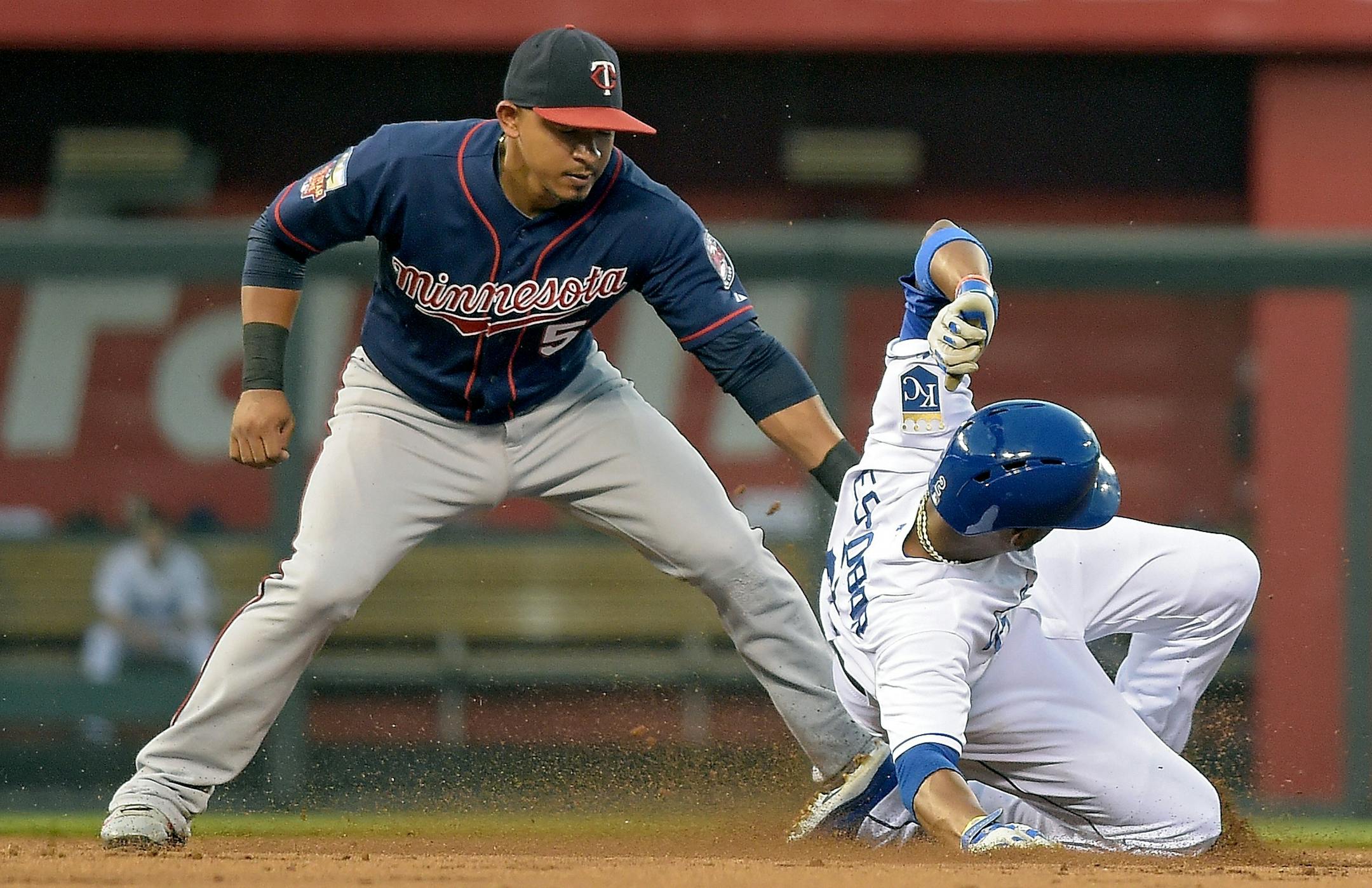 The Kansas City Royals' Alcides Escobar steals second before the tag from Minnesota Twins shortstop Eduardo Escobar (5) in the first inning on Wednesday, Aug. 27, 2014, at Kauffman Stadium in Kansas City, Mo. (John Sleezer/Kansas City Star/MCT)