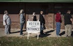 FILE - In this Tuesday, Nov. 3, 2020, file photo, voters wait in line outside a polling center on Election Day, in Kenosha, Wis. Posts shared thousand