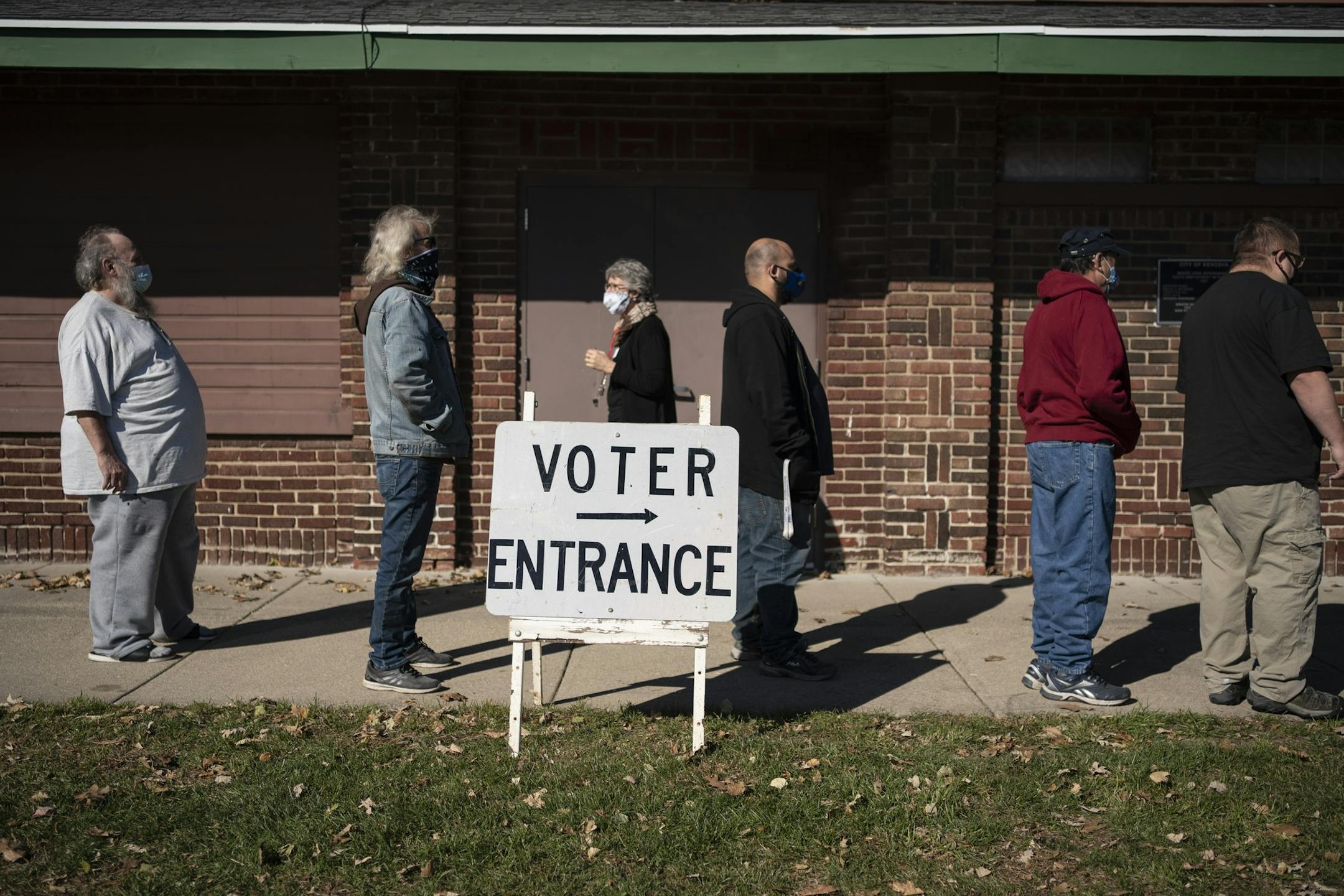 FILE - In this Tuesday, Nov. 3, 2020, file photo, voters wait in line outside a polling center on Election Day, in Kenosha, Wis. Posts shared thousands of times on Facebook, Twitter and Instagram are falsely claiming that an impossible number of people cast ballots in Wisconsin. Meagan Wolfe, the state's top elections official, addressed the social media rumors Thursday, Nov. 5, saying: "Wisconsin does not have more votes than registered voters." (AP Photo/Wong Maye-E, File)
