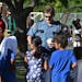 1: Commander Matt Toupal passed out stickers at a St. Paul Safe Summer Nights event. On August 26, there will be a Safe Summer Nights event in Brookly