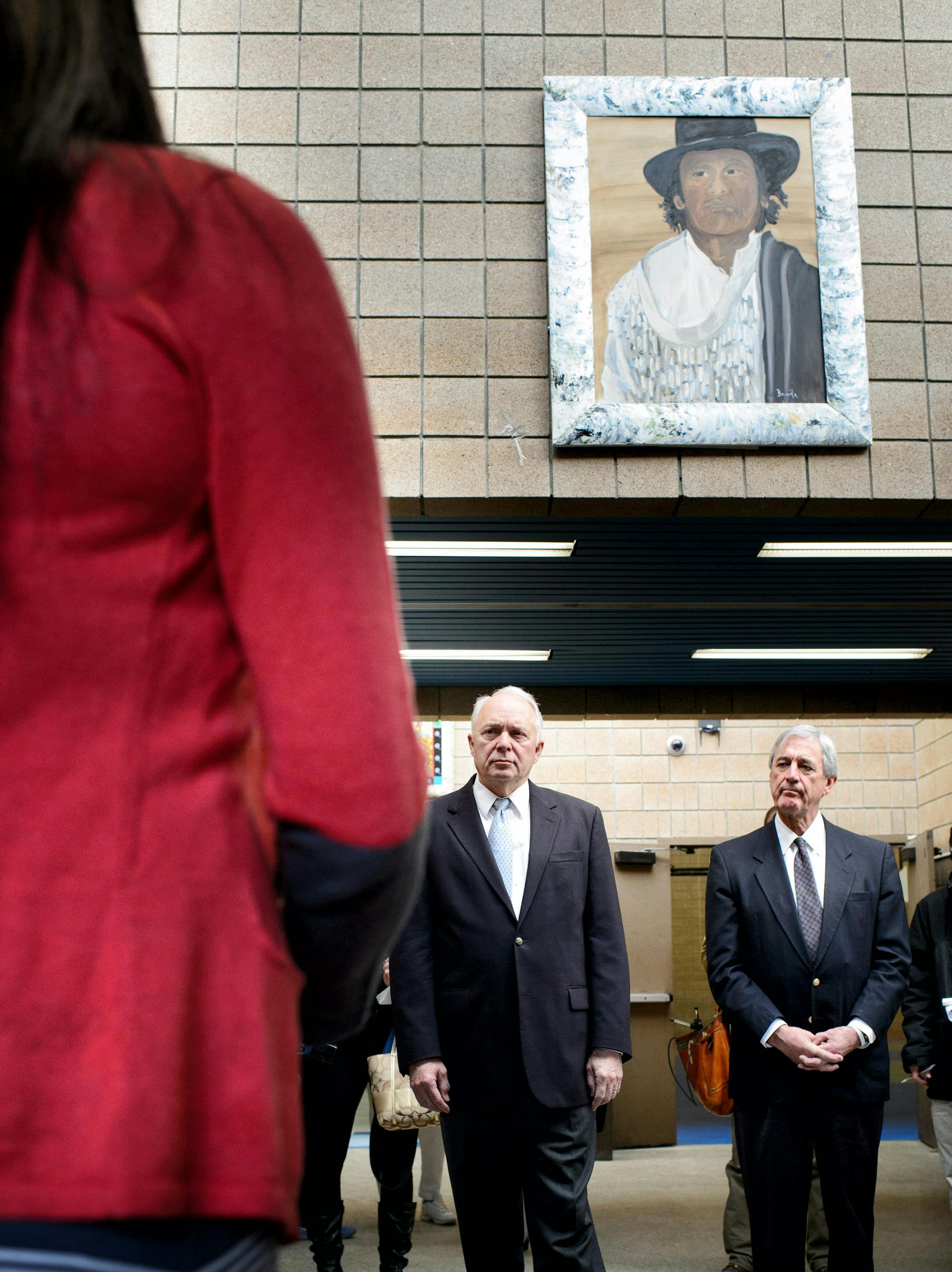Rep. John Kline and Rep. Rick Nolan were welcomed to Bug-O-Nay-Ge-Shig school by superintendent Crystal Redgrave. Hanging over them is a portrait of Bug-O-Nay-Ge-Shig leader who the school was named after.
