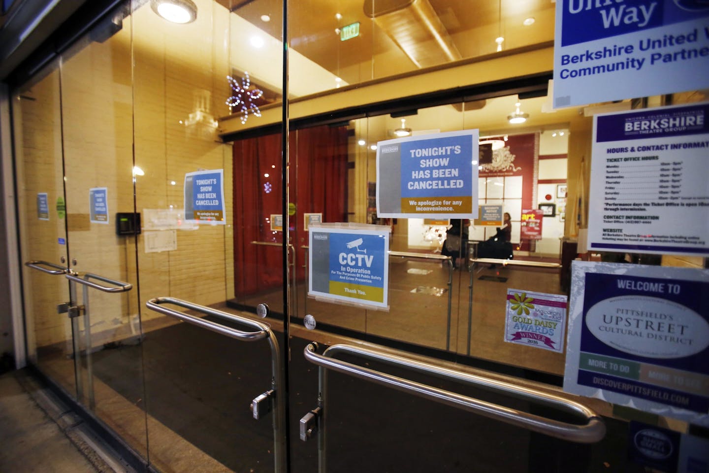 Signs are posted on the doors of the Colonial Theatre in Pittsfield, Mass., announcing the cancellation of a performance featuring radio personality Garrison Keillor with Robin and Linda Williams on Wednesday, Nov. 29, 2017. The sudden cancellation came in the wake of Keillor being fired from Minnesota Public Radio on an allegation of improper behavior.