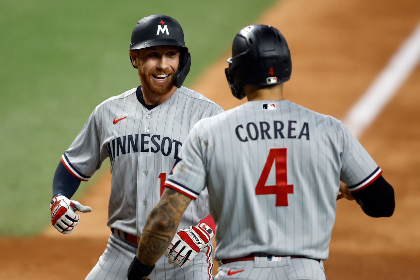 Jordan Luplow is congratulated by Carlos Correa after hitting a two-run home run in the seventh inning against the Rangers on Friday