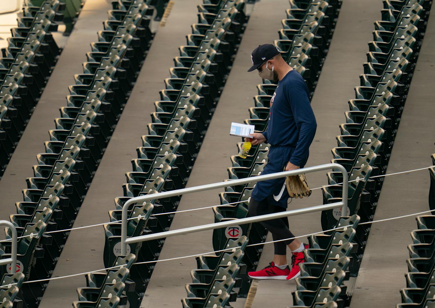 Twins manager Rocco Baldelli checked his notes while walking to the field during workouts Sunday evening. Baldelli plans to stage the first intrasquad game of camp on Wednesday.