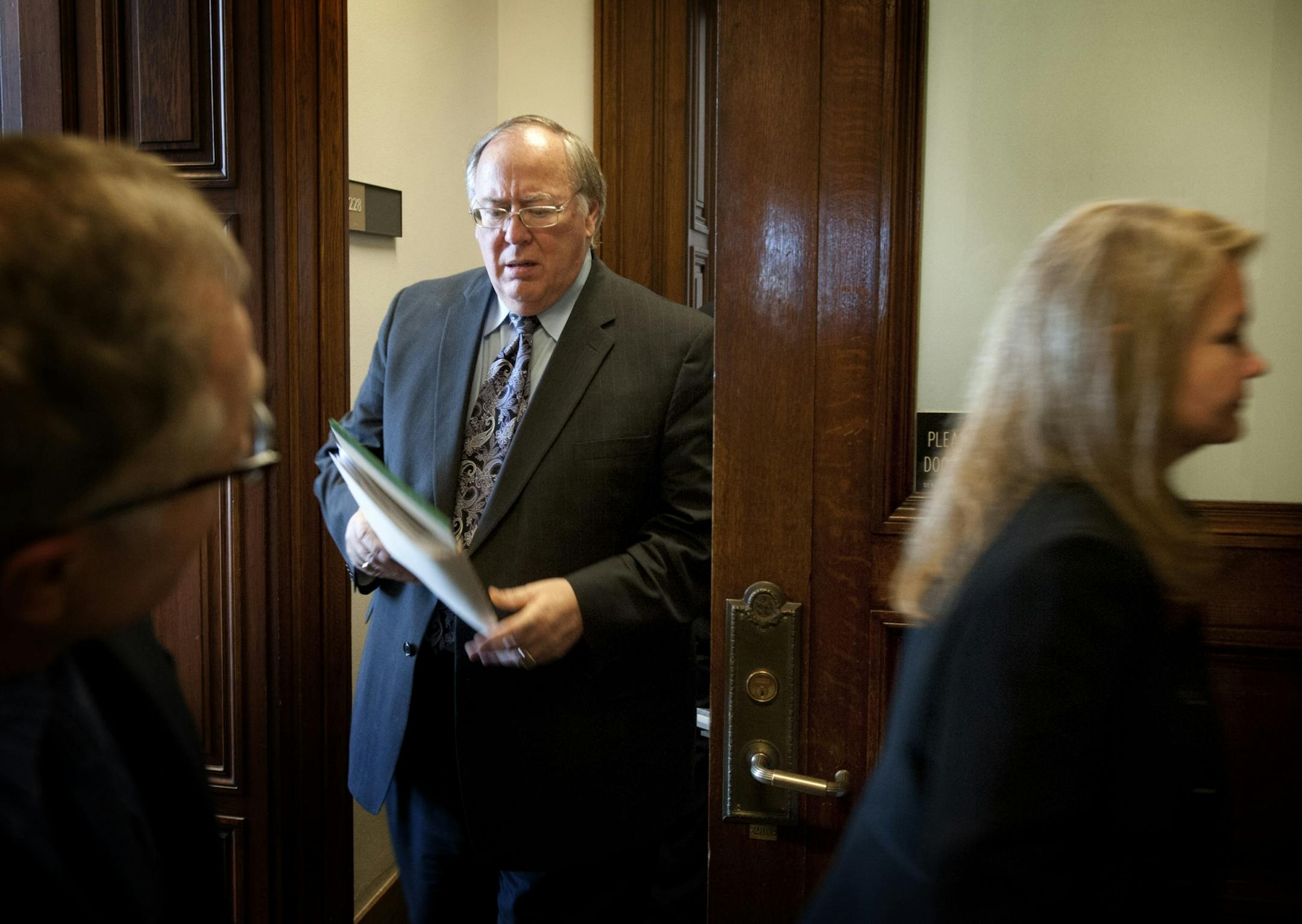 Senate Majority leader David Senjem and Deputy Majority leader Julianne Ortman emerged from a GOP private leadership meeting and headed to a news conference to attempt to explain the new, last minute stadium proposal, Tuesday. At left is Steve Sviggum.