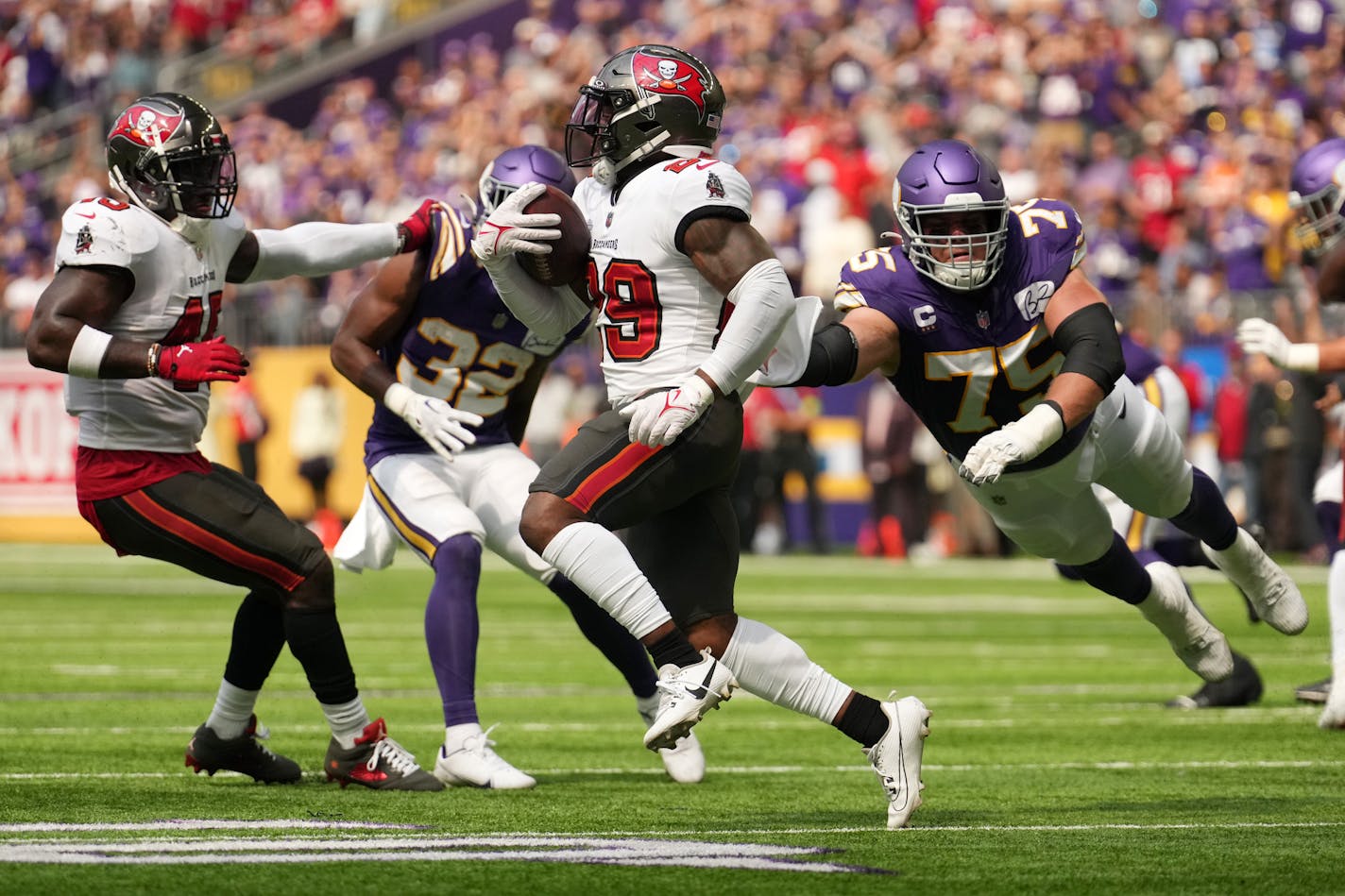 Minnesota Vikings offensive tackle Brian O'Neill (75) leaps after Tampa Bay Buccaneers safety Christian Izien (29) in the second quarter of an NFL game between the Minnesota Vikings and the Tampa Bay Buccaneers Sunday, Sept. 10, 2023 at U.S. Bank Stadium in Minneapolis. ] ANTHONY SOUFFLE • anthony.souffle@startribune.com