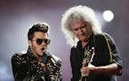 FILE - In this Sept. 19, 2015 file photo, Adam Lambert, left, and Brian May of the Queen + Adam Lambert perform at the Rock in Rio music festival in R
