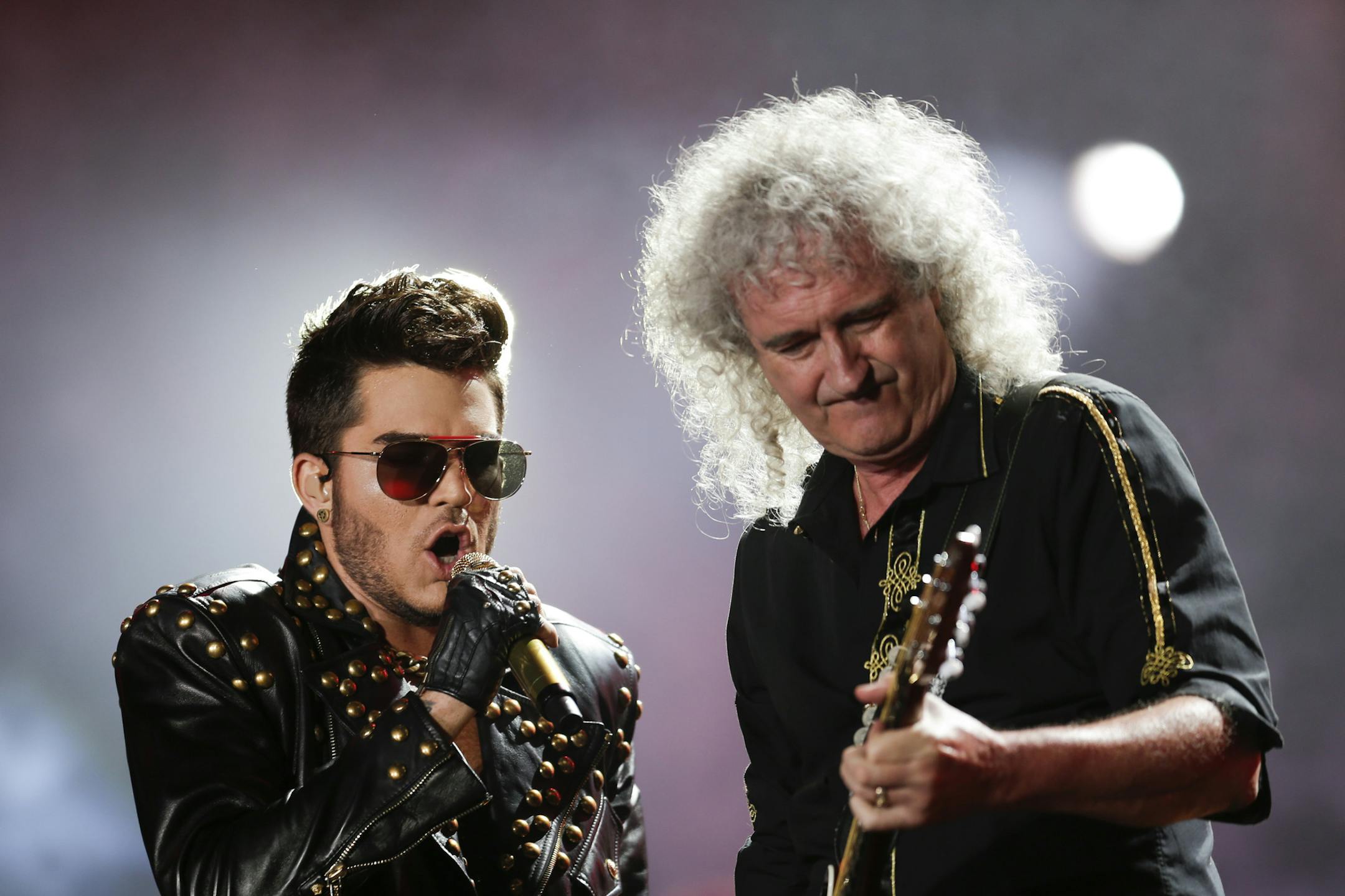 FILE - In this Sept. 19, 2015 file photo, Adam Lambert, left, and Brian May of the Queen + Adam Lambert perform at the Rock in Rio music festival in Rio de Janeiro, Brazil. Many of the rock ëní roll bands that were huge in 1977 will comprise a big part of the summer concert market 40 years later. Concert industry executives say nostalgia acts are still reliable sellers, with satellite and classic rock radio keeping their hits alive. (AP Photo/Felipe Dana, File)