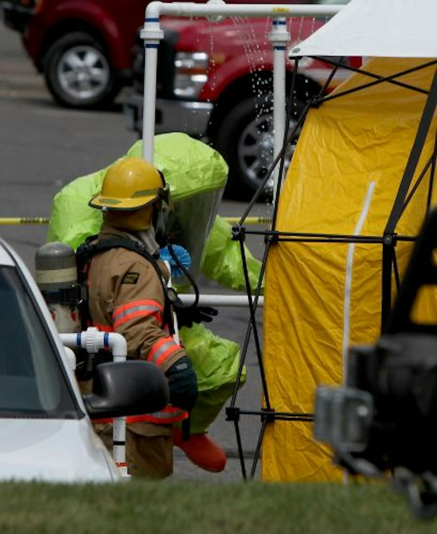 A hazardous materials crew and firefighters contain the chemical spill that occurred at the Crowne Plaza Hotel in Eagan.