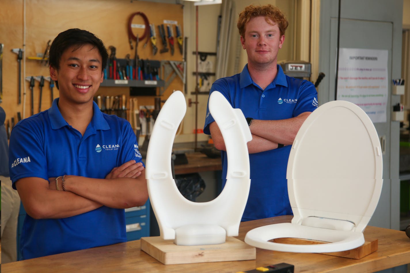 Kevin Tang, left, and Caleb McGrath, of Cleana Inc., with their self-lifting toilet seats in MIT's Lab for Manufacturing and Productivity in Cambridge, Massachusetts. (Reba Saldanha/Boston Herald/TNS)