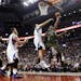 Toronto Raptors' DeMar DeRozan, right, goes to the basket against Minnesota Timberwolves' Nikola Pekov, second from right, during the first half of an