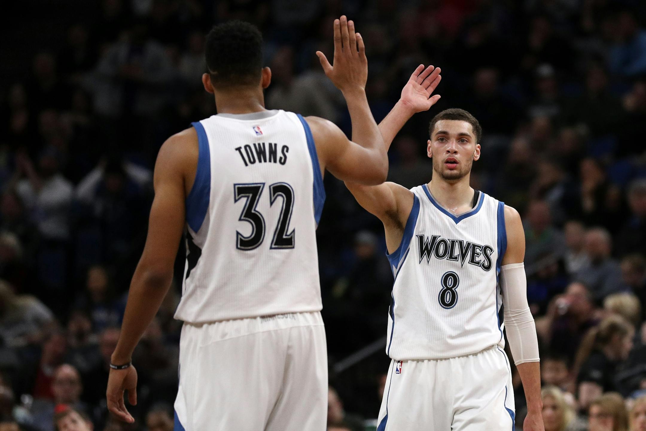 Minnesota Timberwolves center Karl-Anthony Towns (32) celebrates a basket with Minnesota Timberwolves guard Zach LaVine (8) in the first half.