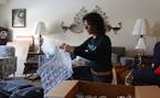 Empty the Nest founder Sharon Fischman packed up a punch bowl at a client's apartment. Empty the Nest is a home clean out service and thrift store. ] 
