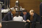 President Barack Obama, left, speaks with Russian President Vladimir Putin, right, before the opening session of the annual G-20 economic summit meeti