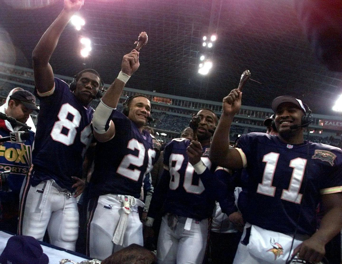 GENERAL INFORMATION: November 23, 2000-- Irving, TX- Minnesota Vikings vs. Dallas Cowboys- Texas Stadium--
IN THIS PHOTO: Minnesota Vikings Randy Moss, Robert Smith, Cris Carter, and Daunte Culpepper, hold up Turkey wings after Thursday's win during a TV inteview on Thanksgiving day.