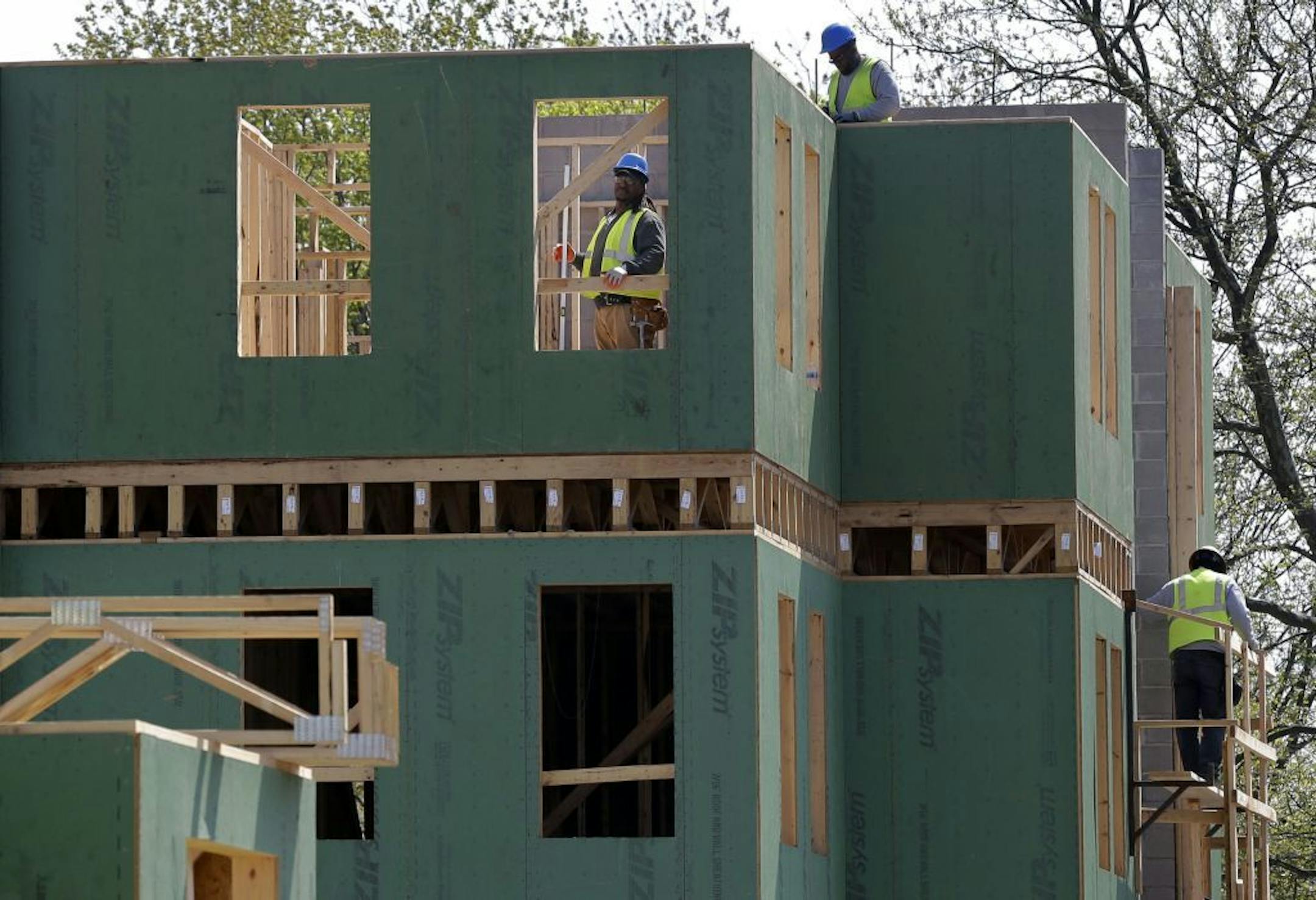In this Wednesday, April 24, 2013, photo, workers are seen at the construction site of a new housing complex, in Trenton, N.J.