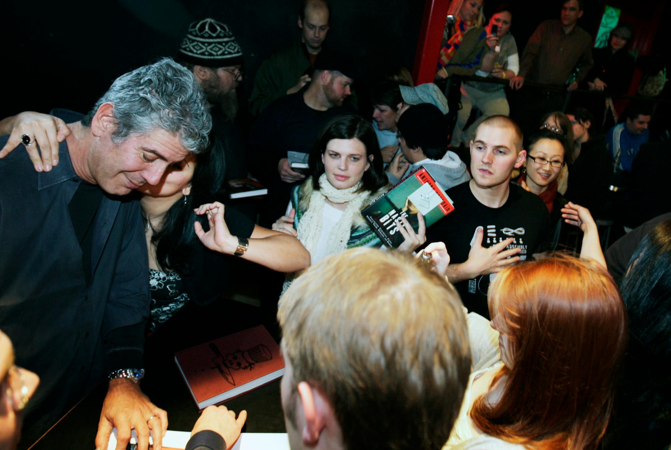 Richard Tsong-Taatarii/rtsong-taatarii@startribune.comMinneapolis, MN;11/26/07;left to right: At the Triple Rock Club, Anthony Bourdain got a kiss from Jessica Maldonado for a picture during the book signing. She described herself as a "foodie to the core." Hundreds of fans hooted and hollered as Bourdain entertained the crowd of food lovers.