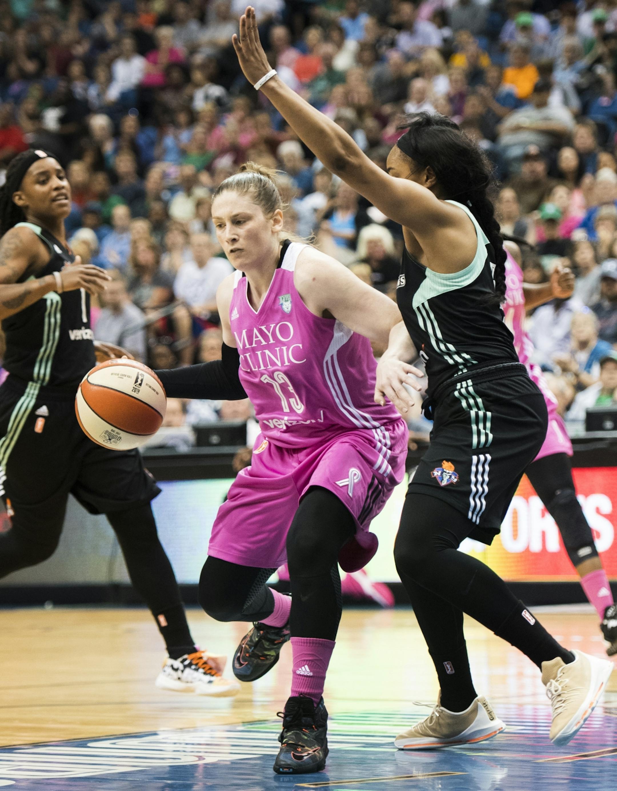 Minnesota Lynx guard Lindsay Whalen (13) drove towards the hoop past New York Liberty guard Brittany Boyd (15).