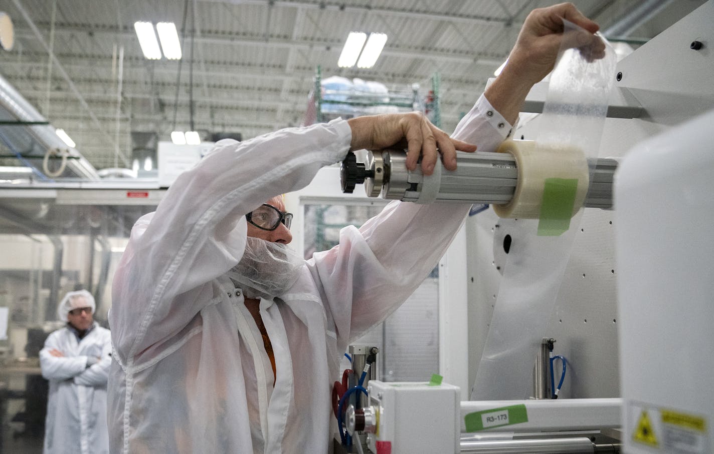 LasX process development technician reloads tape on the roll-to-roll web-based laser converting system in the LasX manufacturing floor. ] LEILA NAVIDI &#xa5; leila.navidi@startribune.com BACKGROUND INFORMATION: LasX Industries, Inc. in White Bear Lake on Friday, December 21, 2018. LasX manufactures a component for a medical device made from laser-cut pieces of laminated tape for a company called Ativa Medical, whose machine for rapid analysis of blood and other biological samples in a doctor&#xd