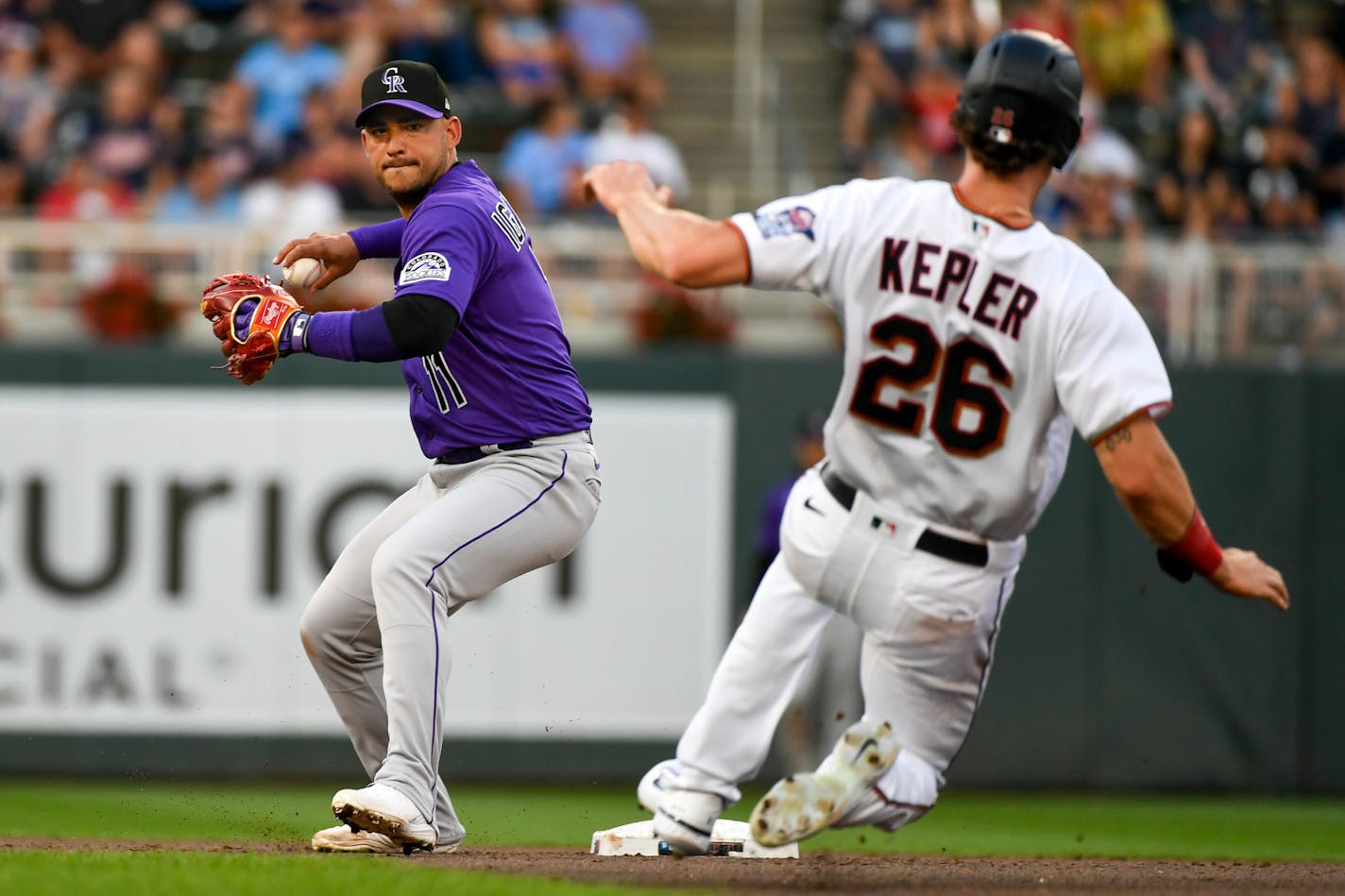 Rockies shortstop Jose Iglesias throws to first after forcing out the Twins' Max Kepler during the fourth inning