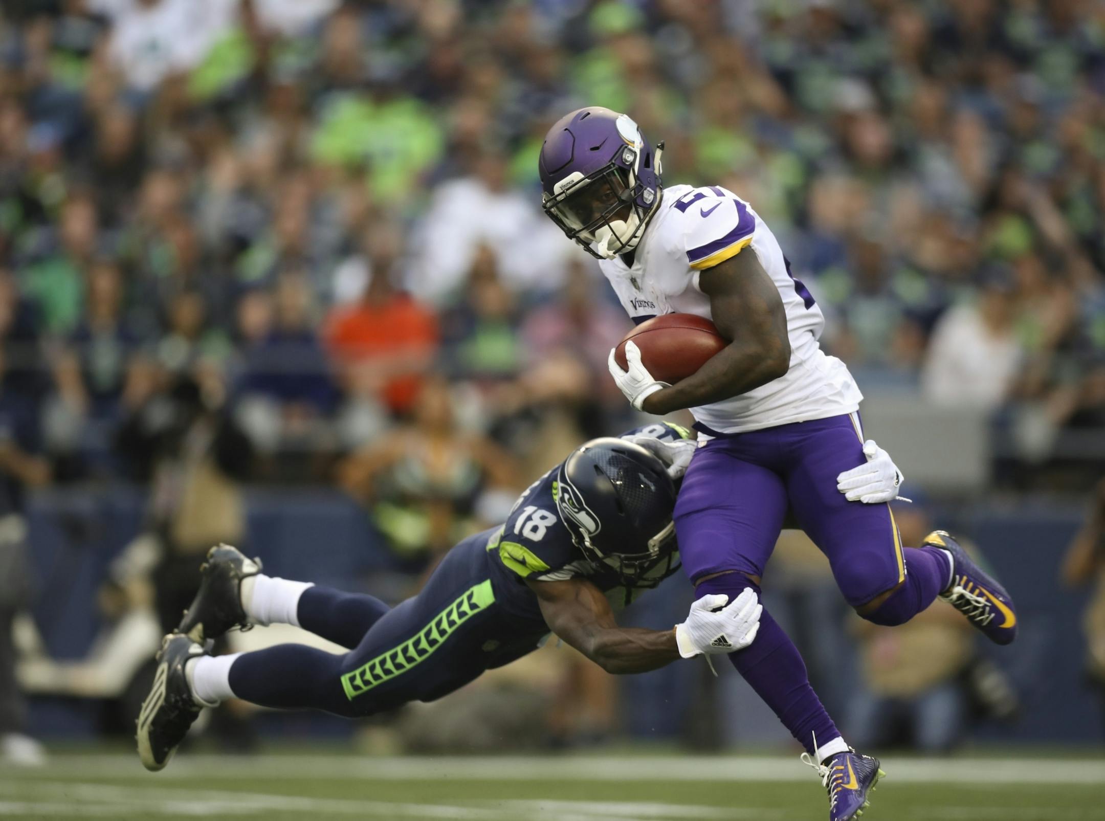 Seattle's Kasen Williams (18) tackled Vikings running back Jerick McKinnon (21) after an eight yard kickoff return during the preseason.