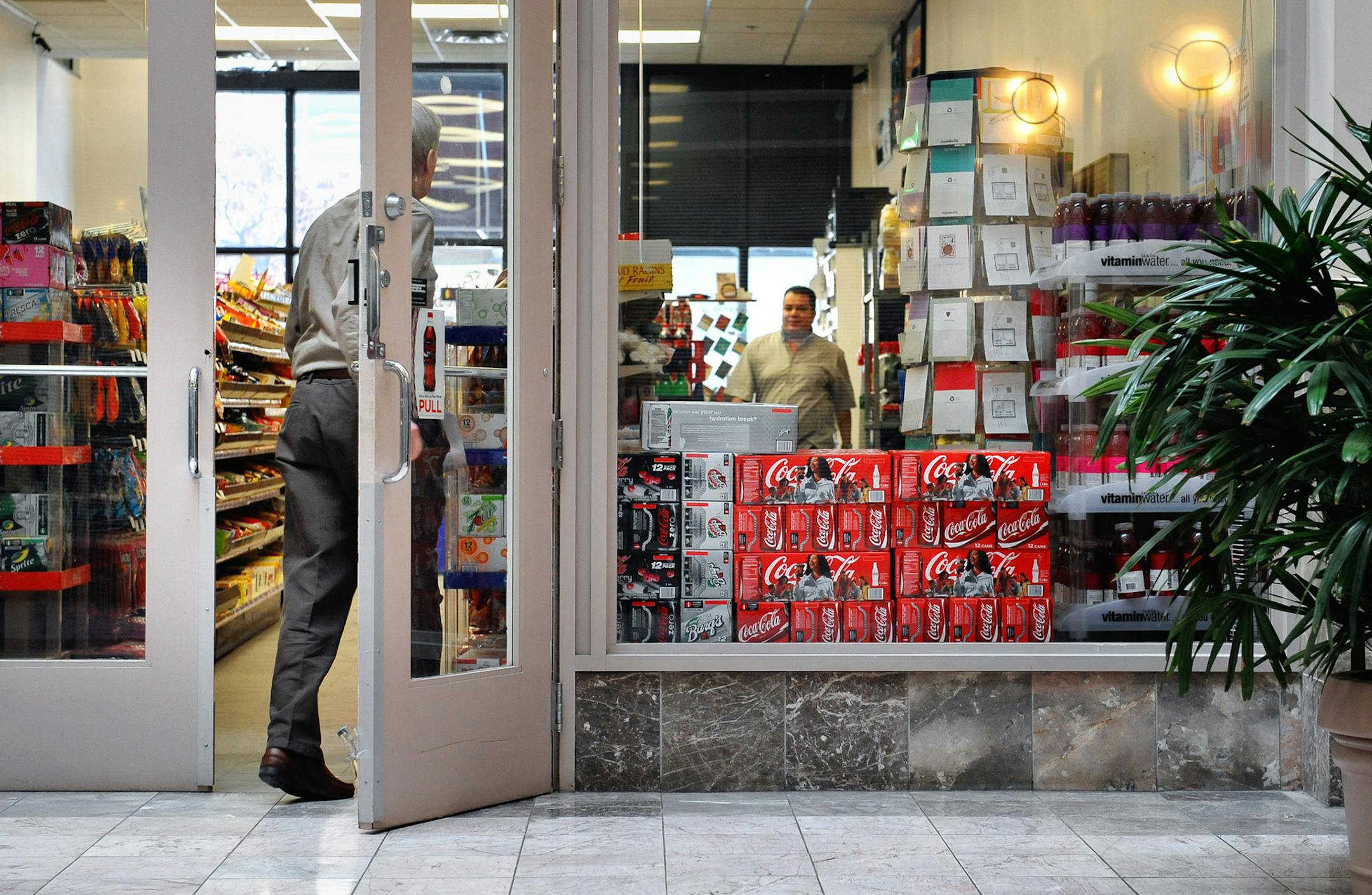 GLEN STUBBE ï gstubbe@startribune.com -- Friday, February 20, 2009 -- Minneapolis, Minn. -- Gamal Hamed greeted a customer in his convenience store, First Avenue Market. He is worried that he may have to close since many of his former customers have been laid off. ORG XMIT: MIN2017080215182043