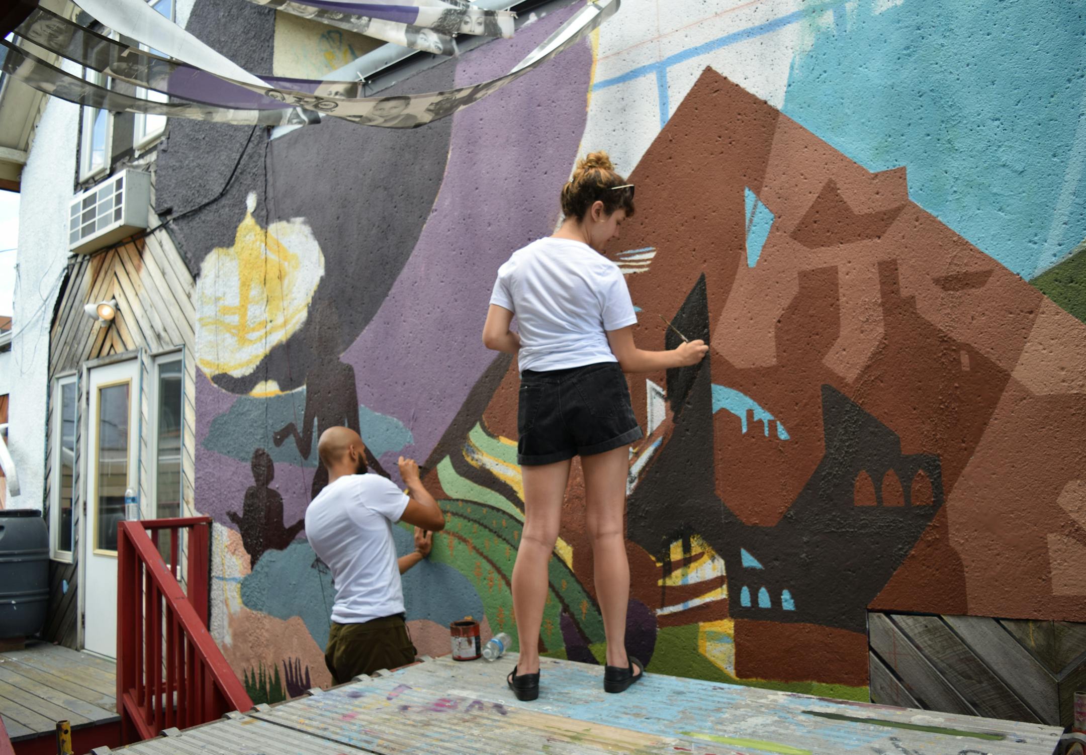 Artists working on mural for Flow Art Crawl.