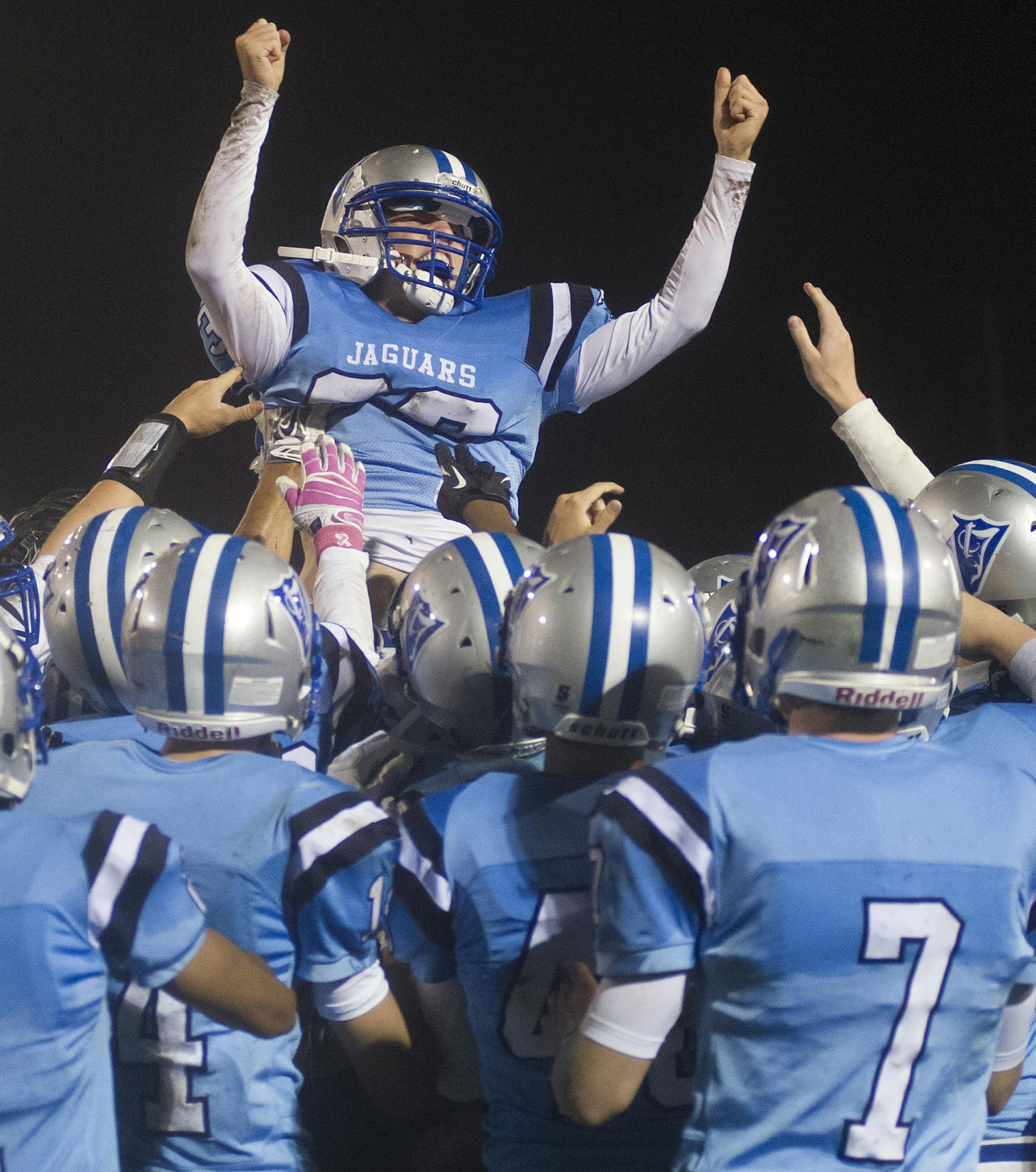 Jefferson High School kicker Ted Kalina is hoisted up by his teammates after kicking the game winning field goal in overtime Thursday night to give Jefferson a 17-14 win over Cooper at home. ] (Matthew Hintz, 100214, Bloomington)