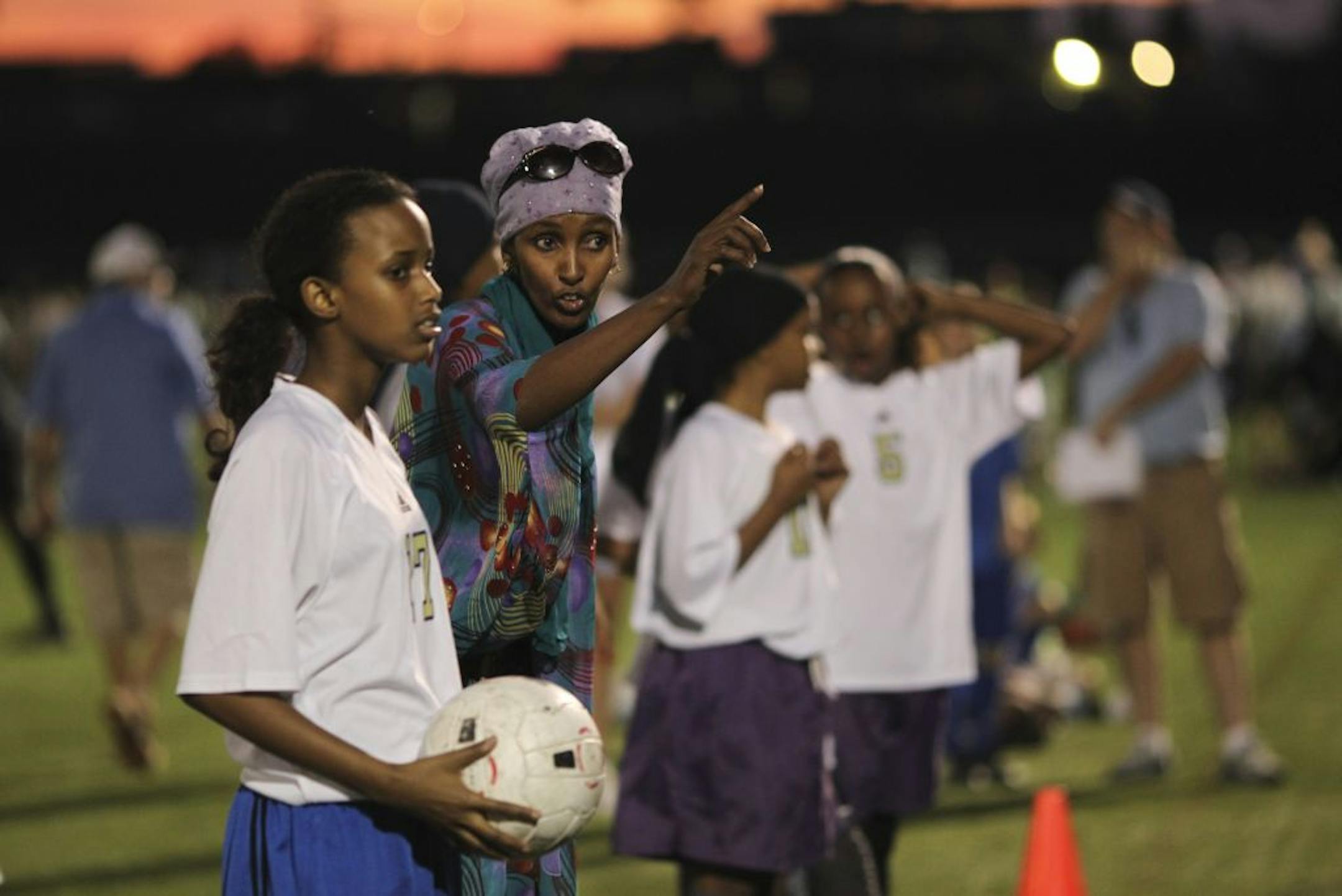 Coach Fartun Osman showed Safiya Muse where she should throw the ball Tduring her team's game at McMurray Field in St. Paul, Minn. Thursday evening, September 8, 2011. Coach Fartun Osman has taught hundreds of young Muslim girls how to compete in soccer and track and has been a mentor and friend to their families. She is one of six Minnesotans who will be awarded the Virginia McKnight Binger Human Services Award on Friday. "People look at these girls and assume if you're a Muslim girl with a jih