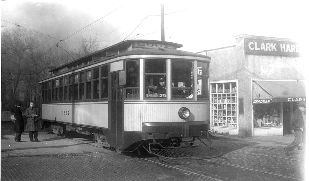Car 1267 in service on the Como-Harriet line crossing Upton Avenue in Linden Hills. Clark Hardware, now Martina Restaurant, is at right.